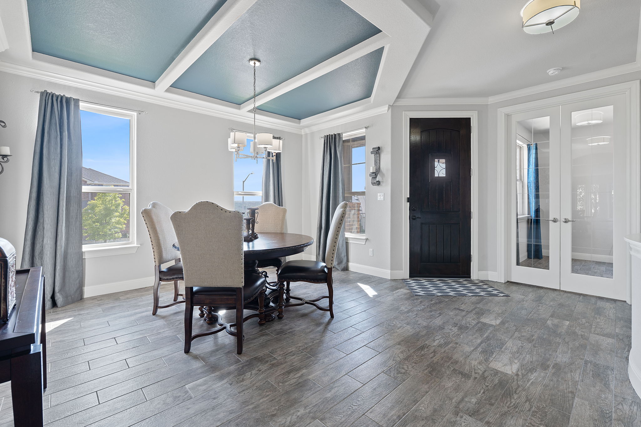 4212 Borho Ranch Street Leander, TX 78641 - Photo 13 of 37 Dining area with wood finished floors, french doors, a chandelier, healthy amount of natural light, and beam ceiling
