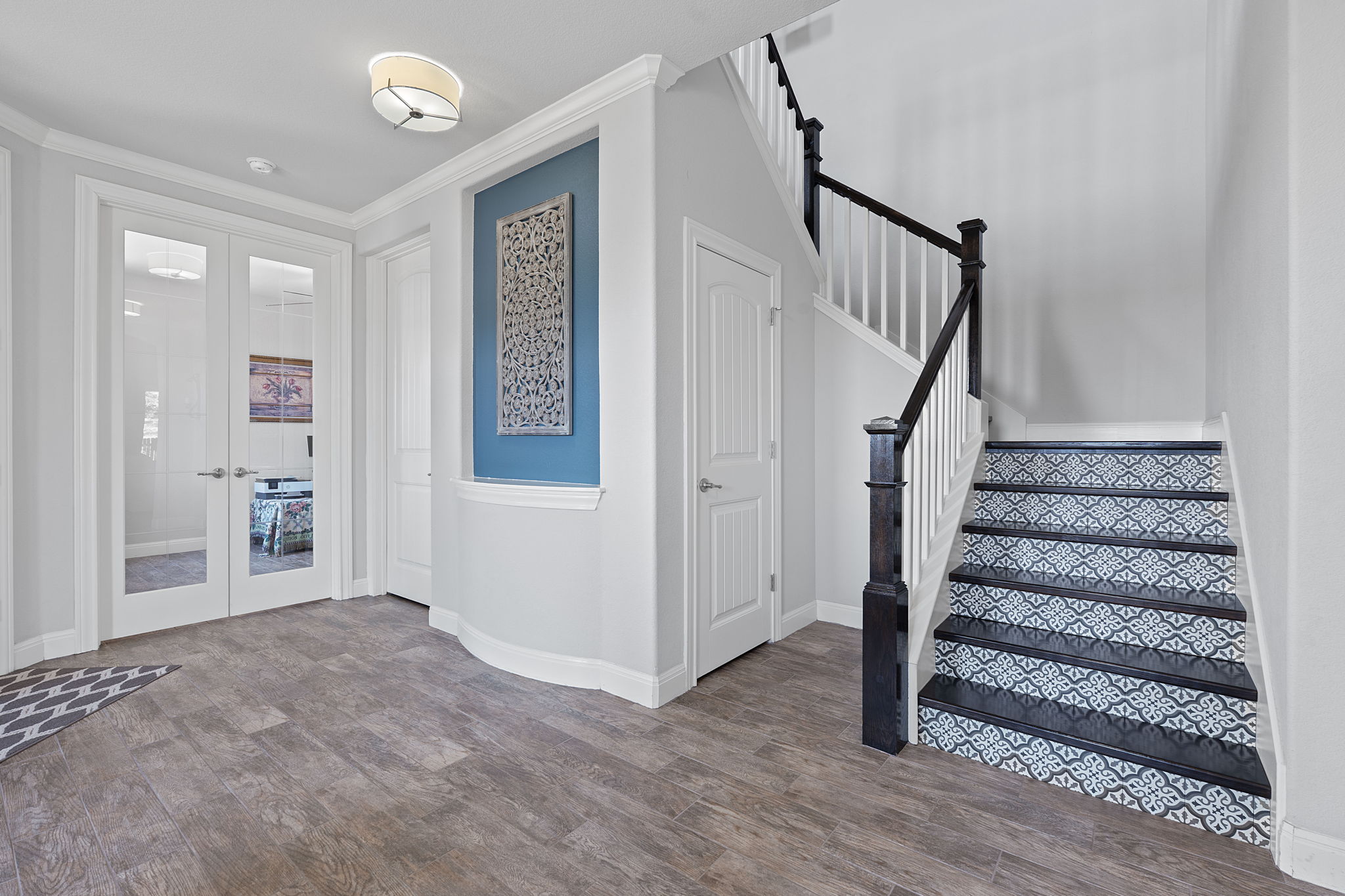 4212 Borho Ranch Street Leander, TX 78641 - Photo 15 of 37 Entryway featuring french doors, wood finished floors, stairway, and crown molding