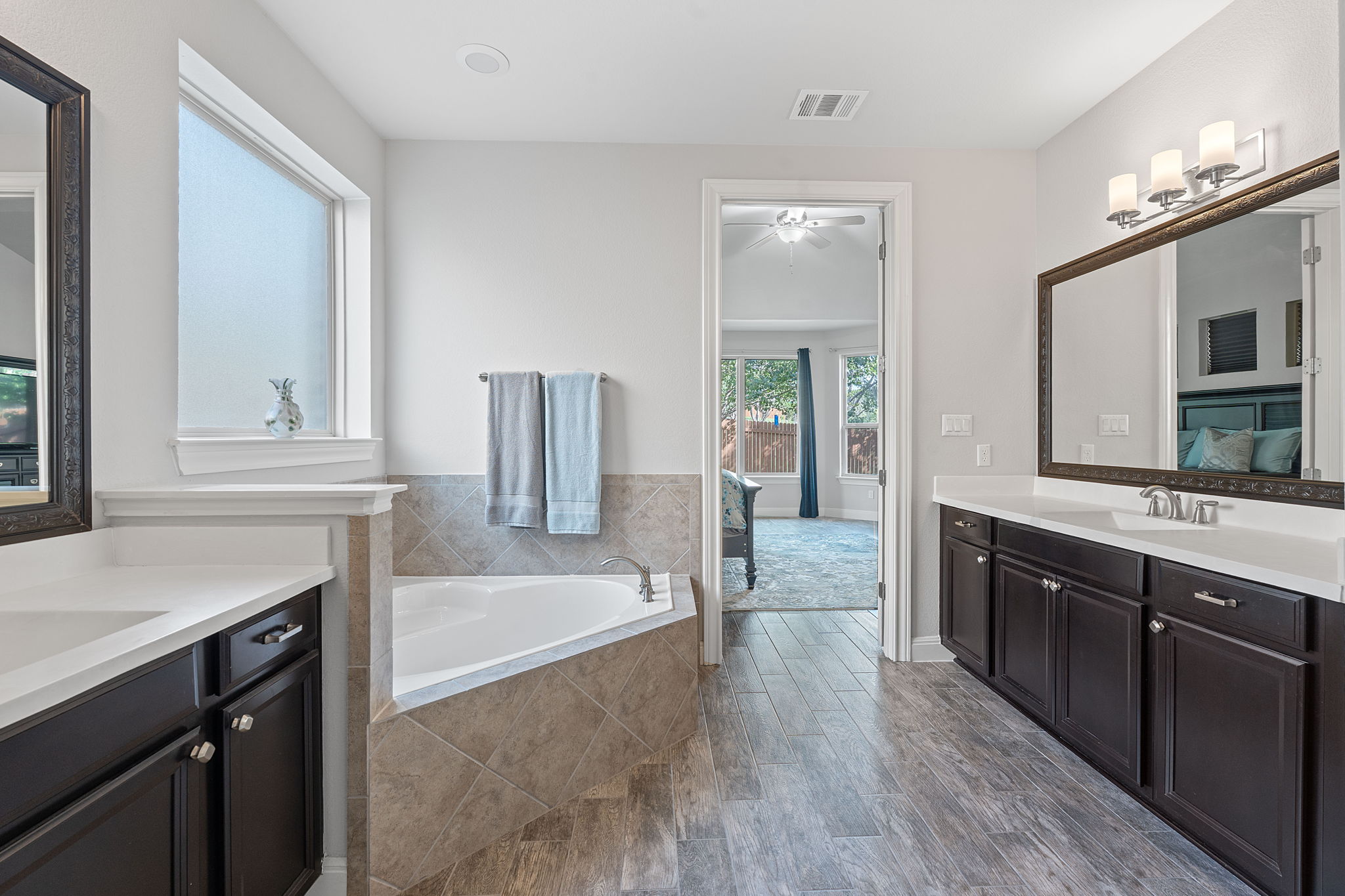 4212 Borho Ranch Street Leander, TX 78641 - Photo 17 of 29 a spacious bathroom with a tub sink and mirror