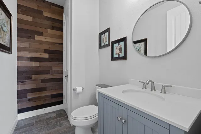 a bathroom with a sink a toilet and a mirror
