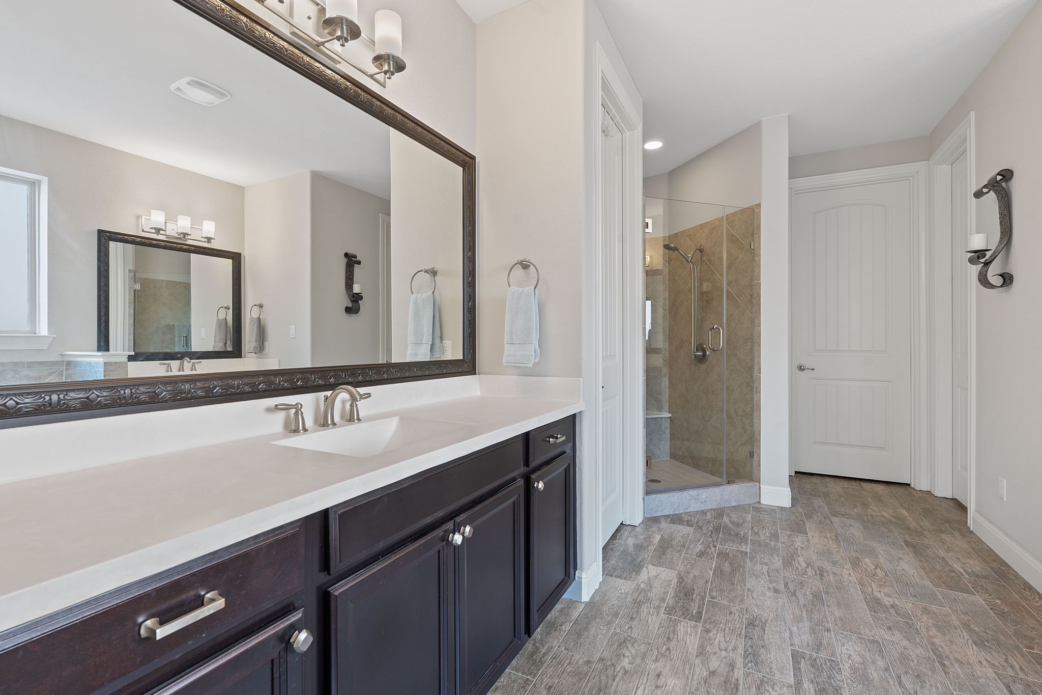 4212 Borho Ranch Street Leander, TX 78641 - Photo 22 of 37 Full bath featuring vanity, a shower stall, and wood finished floors