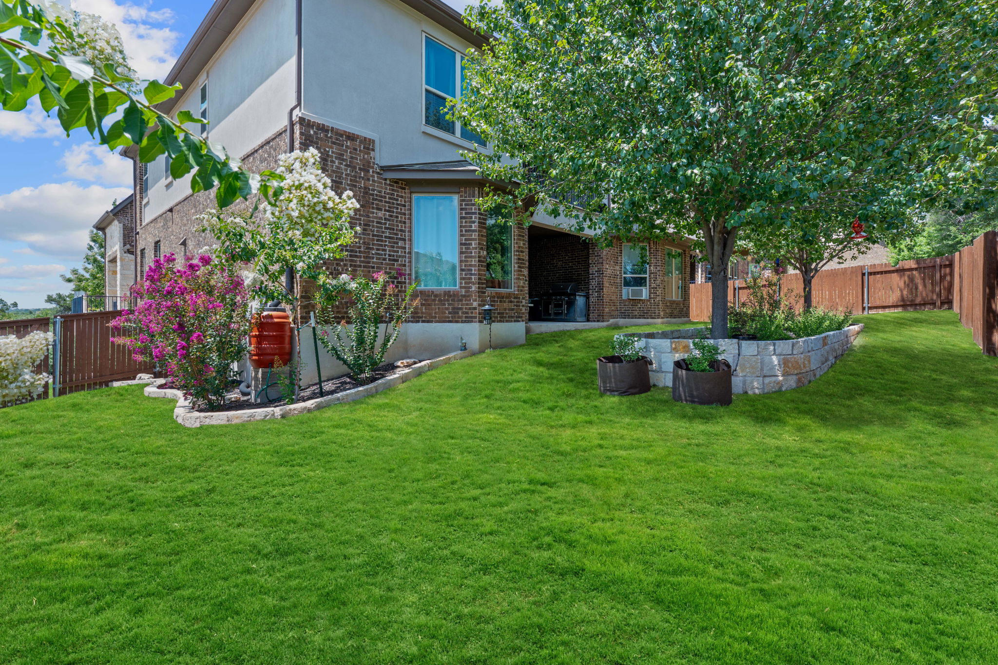 4212 Borho Ranch Street Leander, TX 78641 - Photo 28 of 29 a view of a house with backyard and a garden
