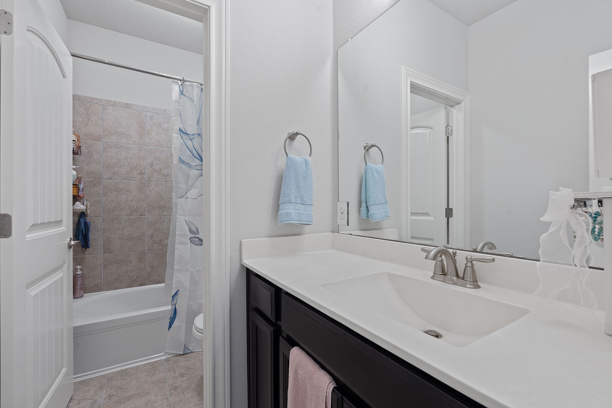 4212 Borho Ranch Street Leander, TX 78641 - Photo 28 of 37 Bathroom with vanity, shower / tub combo, and tile patterned flooring