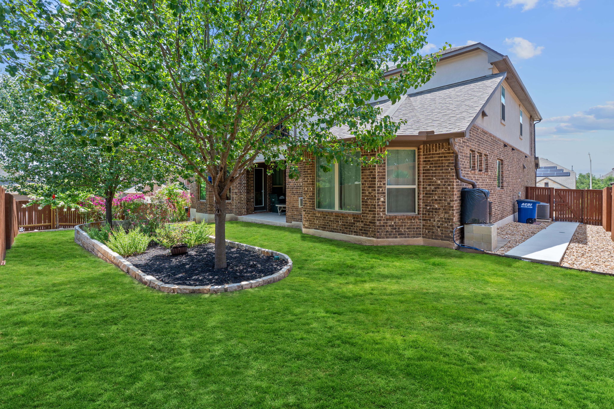 4212 Borho Ranch Street Leander, TX 78641 - Photo 32 of 37 Rear view of property featuring brick siding, a fenced backyard, a patio, and a shingled roof