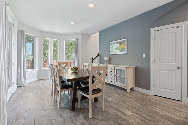 a view of a dining room with furniture window and wooden floor