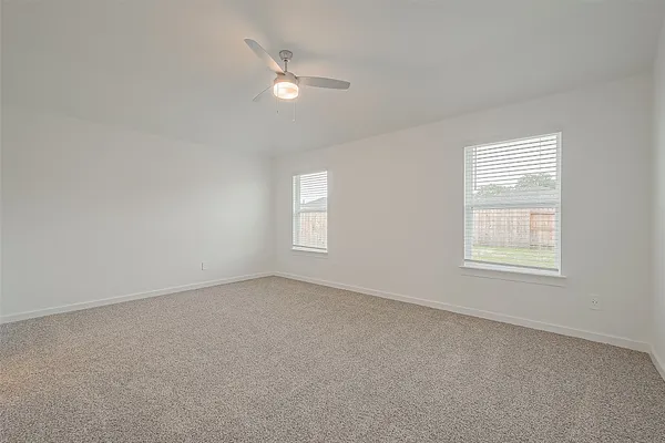 an empty room with a chandelier fan