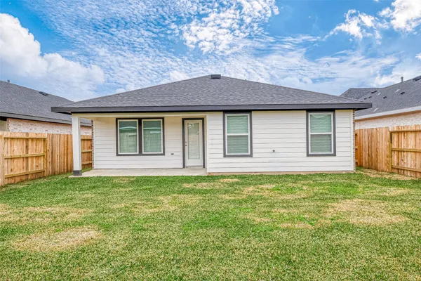 a view of a house with a backyard