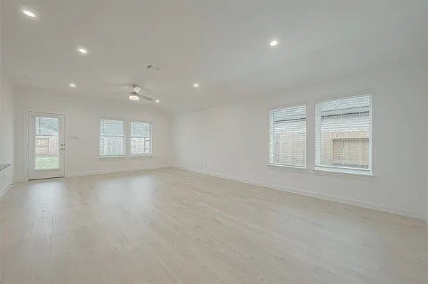 an empty room with windows and closet