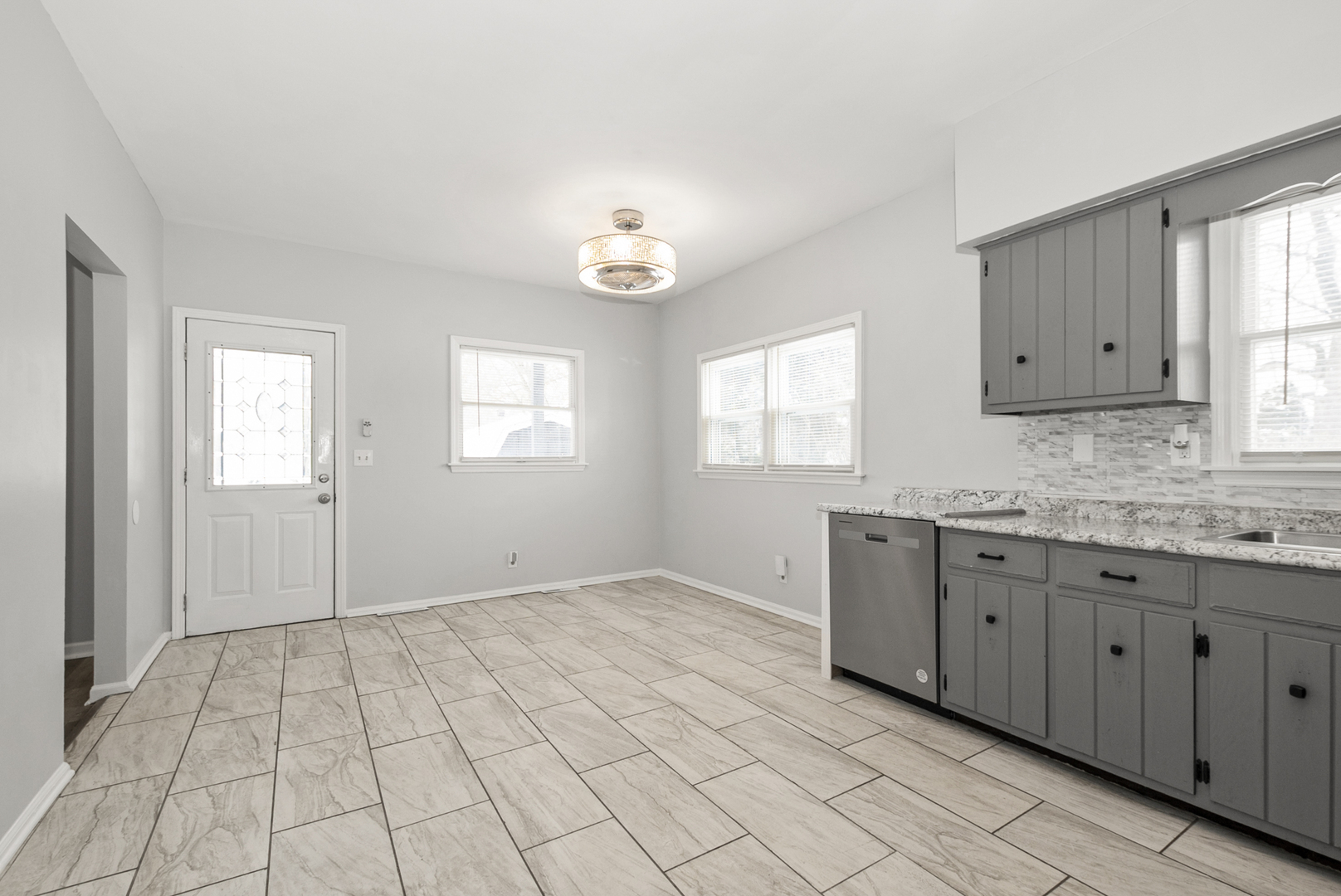 8340 West Lincoln Highway, Unit 8340 Frankfort, IL 60423 - Photo 4 of 12 an empty room with windows and cabinet