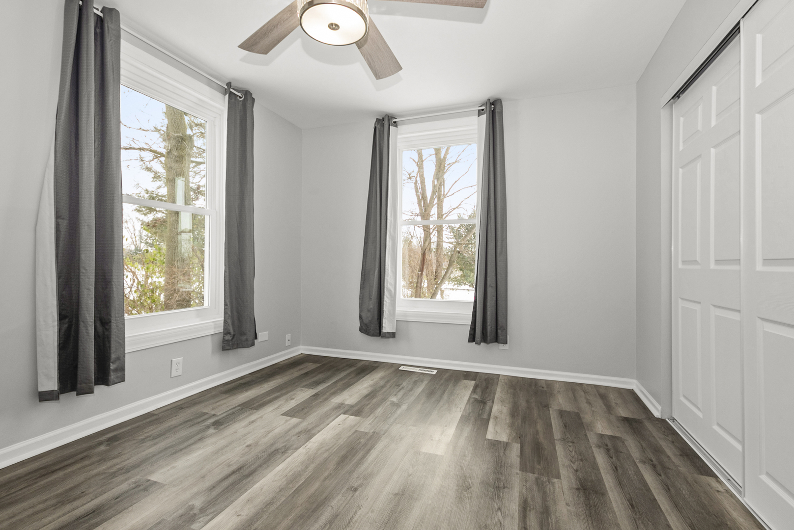8340 West Lincoln Highway, Unit 8340 Frankfort, IL 60423 - Photo 6 of 12 an empty room with wooden floor and windows