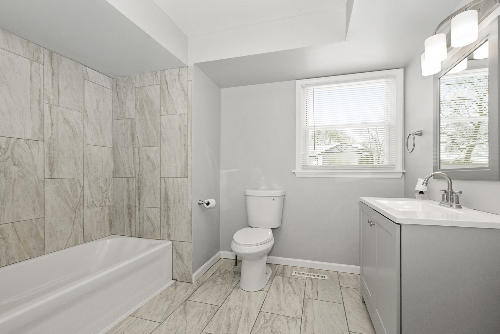 8340 West Lincoln Highway, Unit 8340 Frankfort, IL 60423 - Photo 9 of 12 a bathroom with a sink a toilet and a bathtub