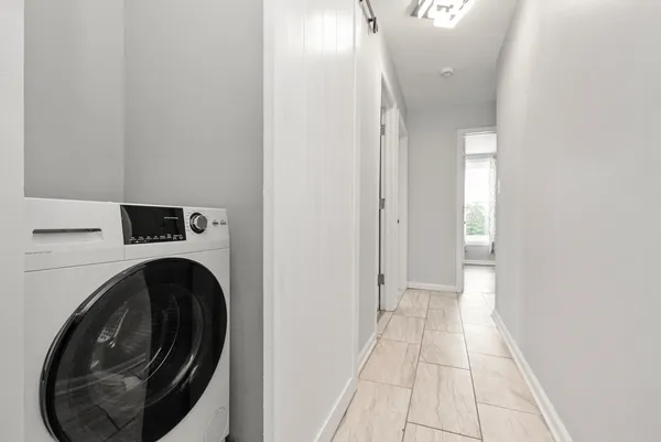 a view of a hallway with washer and dryer