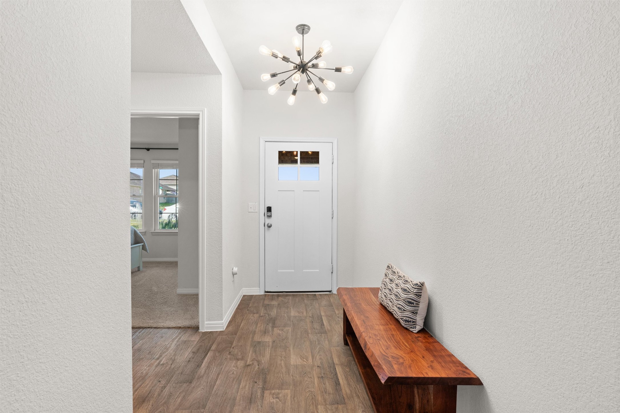 19912 Abigail Fillmore Road Manor, TX 78653 - Photo 6 of 31 A spacious foyer welcomes you with wood flooring and a contemporary chandelier.
