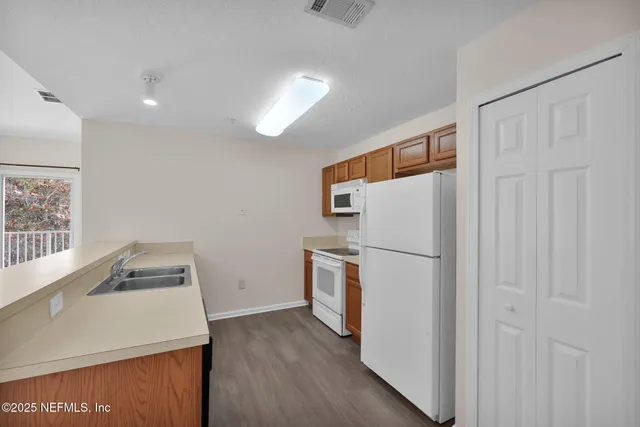 a white refrigerator freezer sitting inside of a kitchen