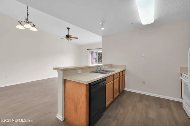 a kitchen with a stove and a wooden floor