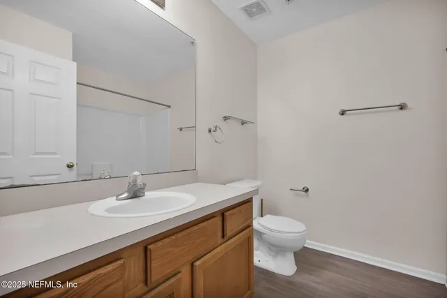 a bathroom with a sink toilet and a mirror