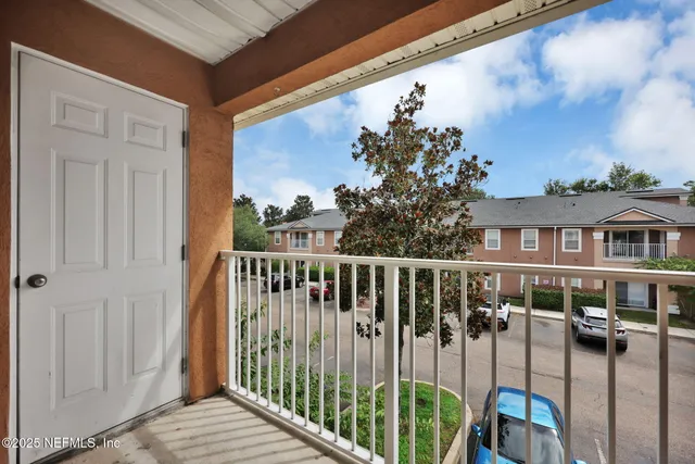 a car parked in front of a house next to a yard