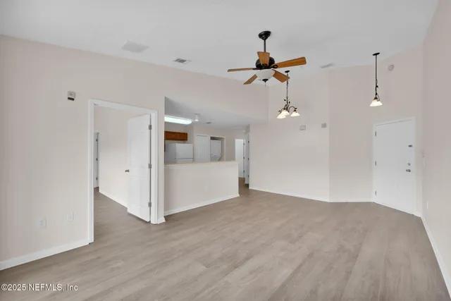 a view of a room with wooden floor