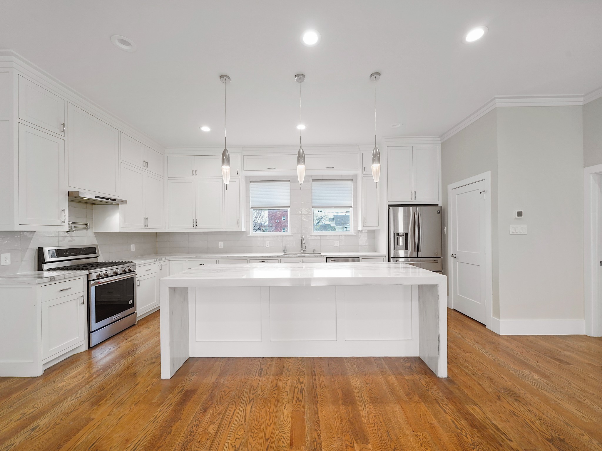 1512 Thompson Street, Unit 2 Houston, TX 77007 - Photo 16 of 39 Chef-inspired kitchen with oversized island, marble countertops, and generous prep space.