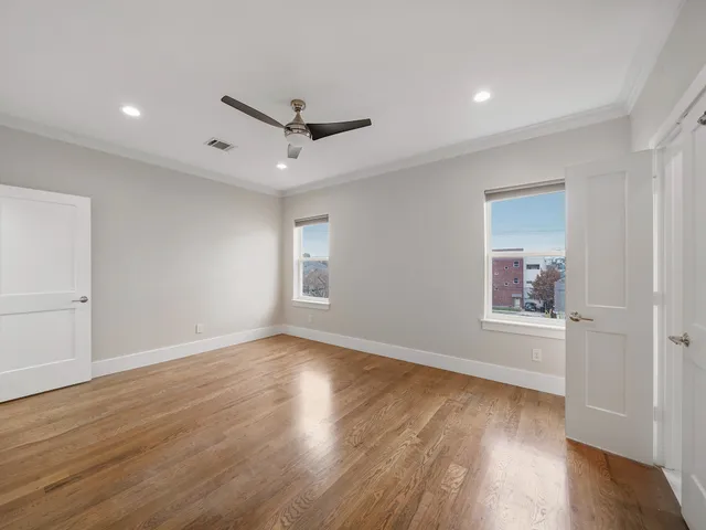 wooden floor in an empty room with a window