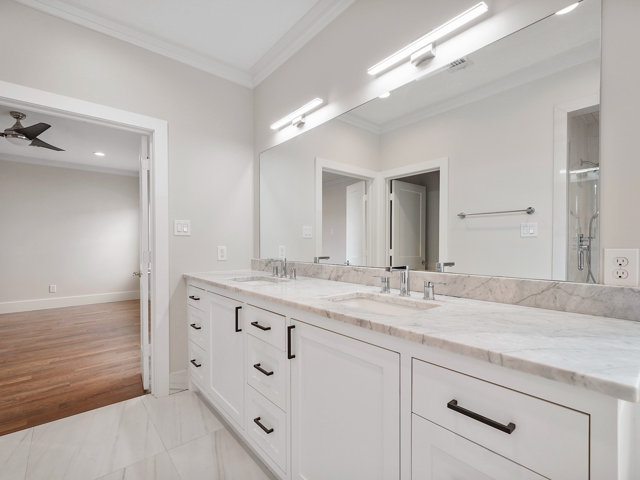 1512 Thompson Street, Unit 2 Houston, TX 77007 - Photo 27 of 39 Additional view of the primary bath emphasizing the wide countertop, modern lighting, and thoughtful layout.