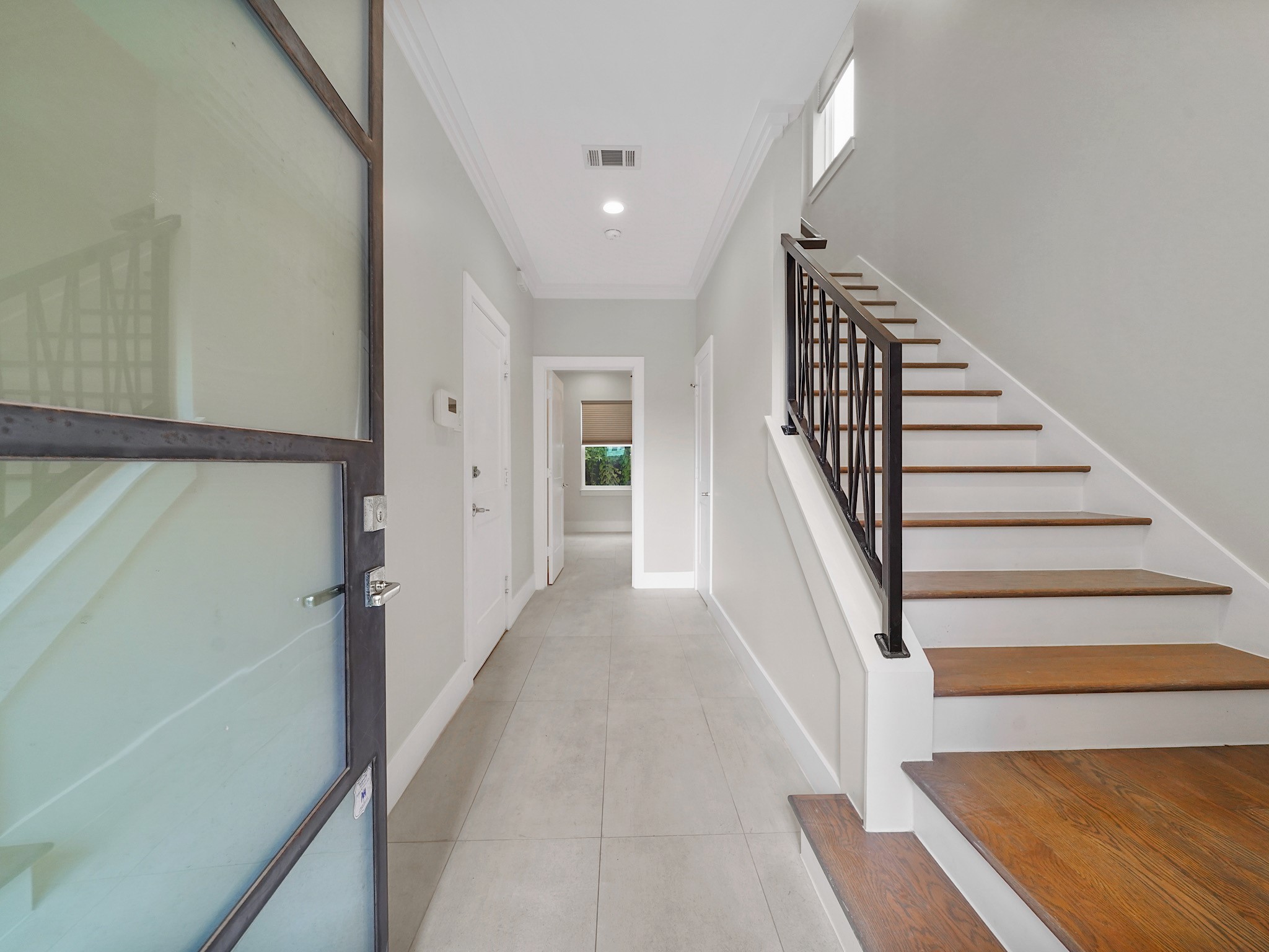 1512 Thompson Street, Unit 2 Houston, TX 77007 - Photo 4 of 39 Bright entry hallway with sleek finishes and direct access to the upper living levels.