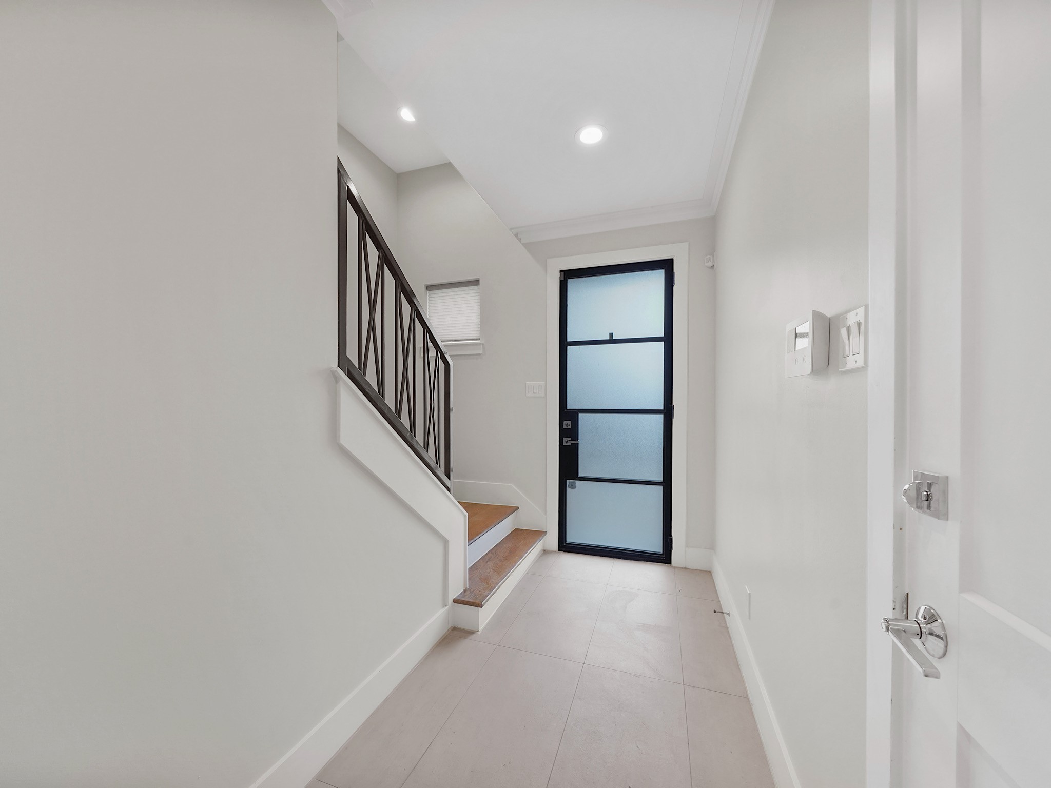 1512 Thompson Street, Unit 2 Houston, TX 77007 - Photo 9 of 39 Welcoming stairwell with modern railing leading to the main living level.