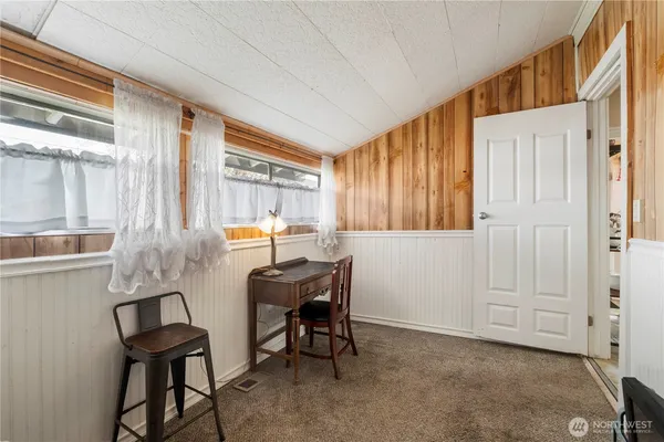 a view of a room with furniture and a window