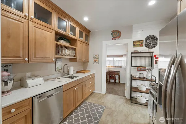 a kitchen with stainless steel appliances granite countertop a refrigerator and a stove