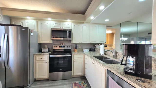 a kitchen with a sink stove and refrigerator
