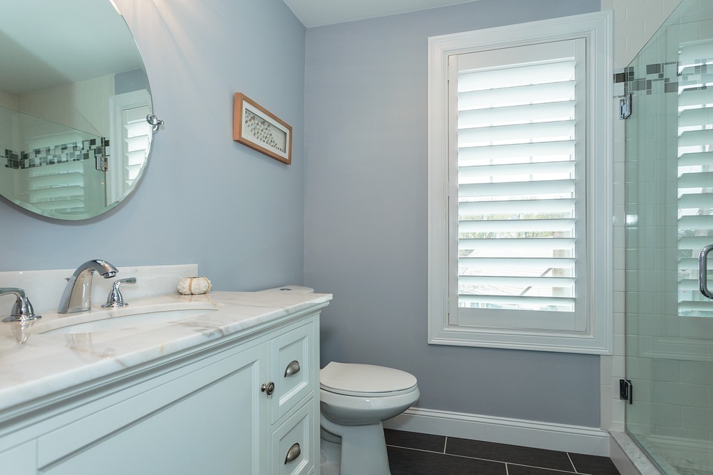 40 Catherine Street, Unit 2 Boston, MA 02131 - Photo 11 of 26 a bathroom with a toilet a sink and a window