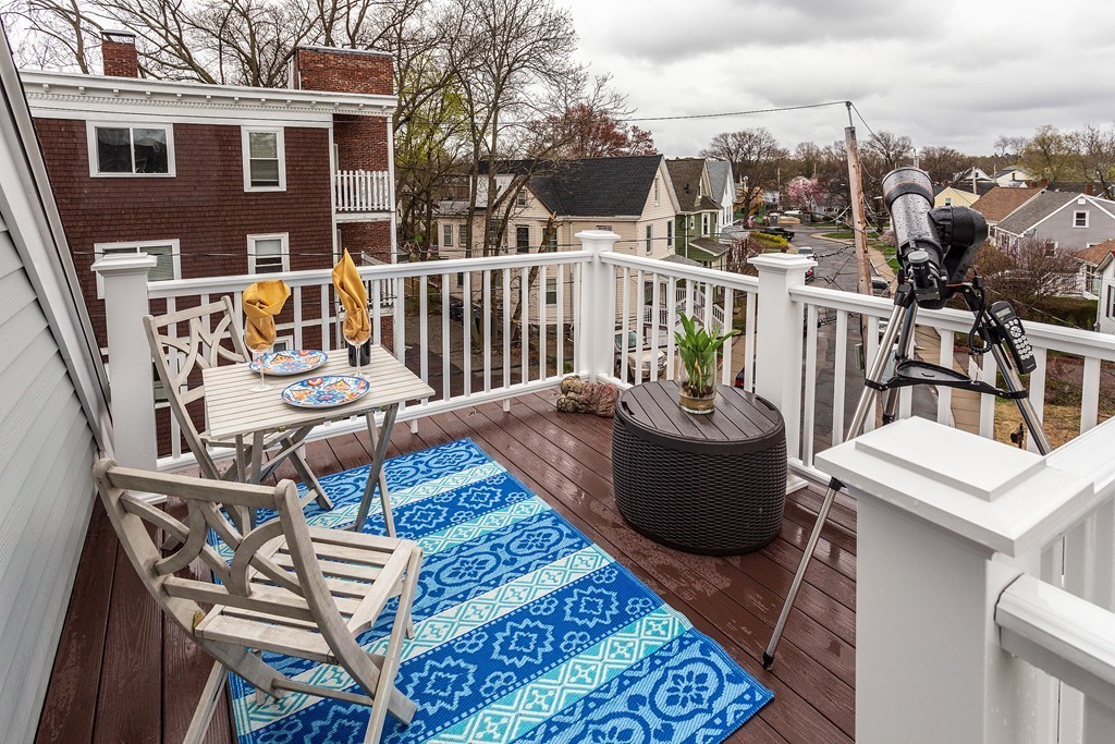 40 Catherine Street, Unit 2 Boston, MA 02131 - Photo 15 of 26 a view of a patio with couches chairs and wooden floor