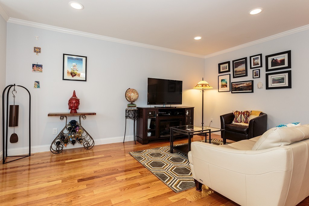 40 Catherine Street, Unit 2 Boston, MA 02131 - Photo 7 of 26 a living room with furniture and a flat screen tv with wooden floor