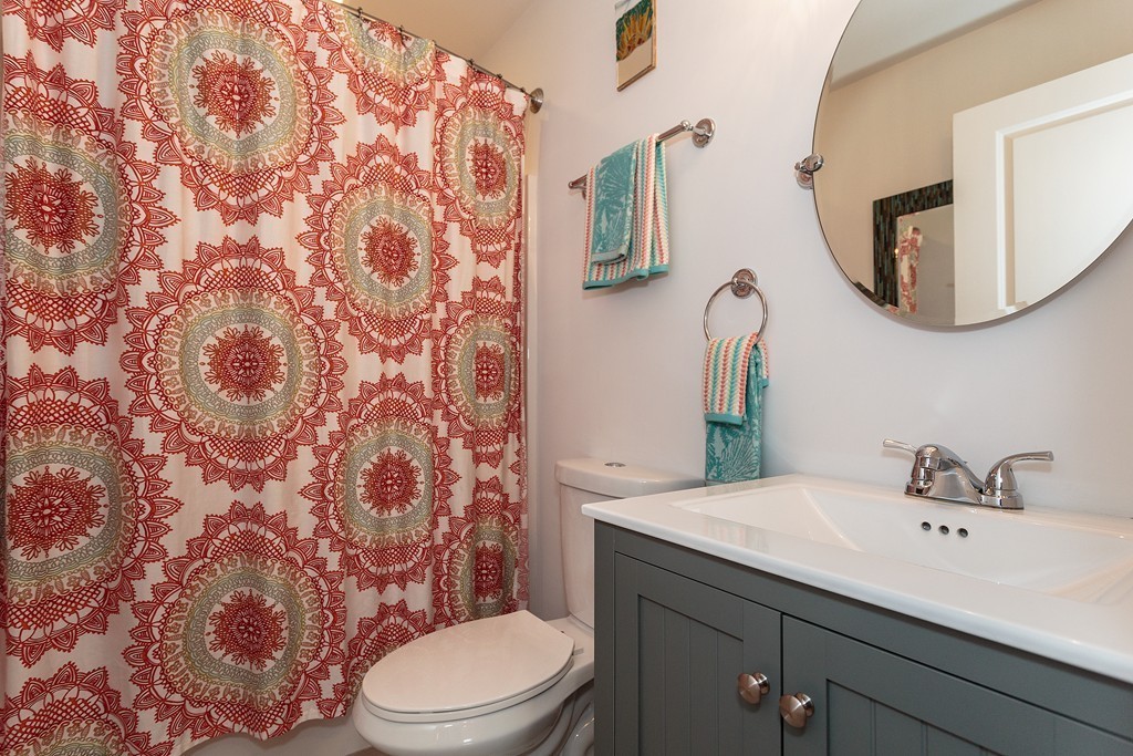 40 Catherine Street, Unit 2 Boston, MA 02131 - Photo 9 of 26 a bathroom with a toilet a sink and mirror