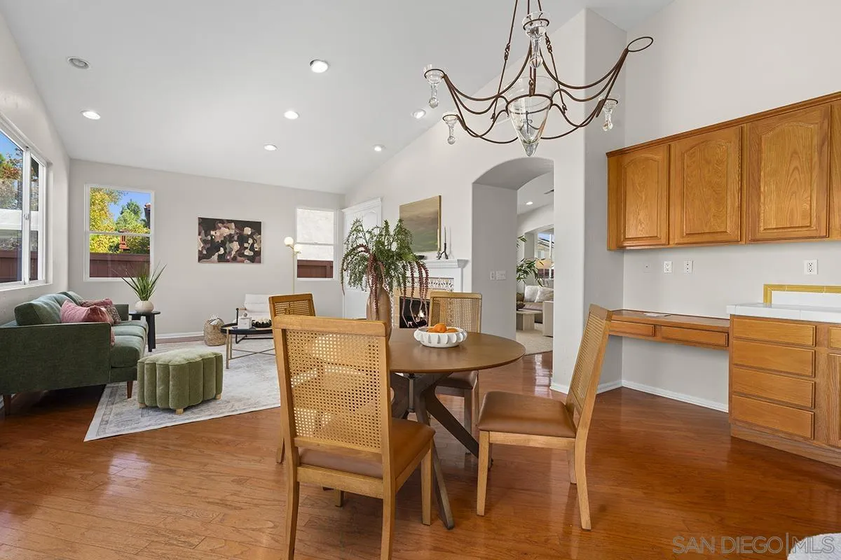 987 Palencia Court Chula Vista, CA 91910 - Photo 19 of 70 a view of a dining room with furniture wooden floor and a chandelier