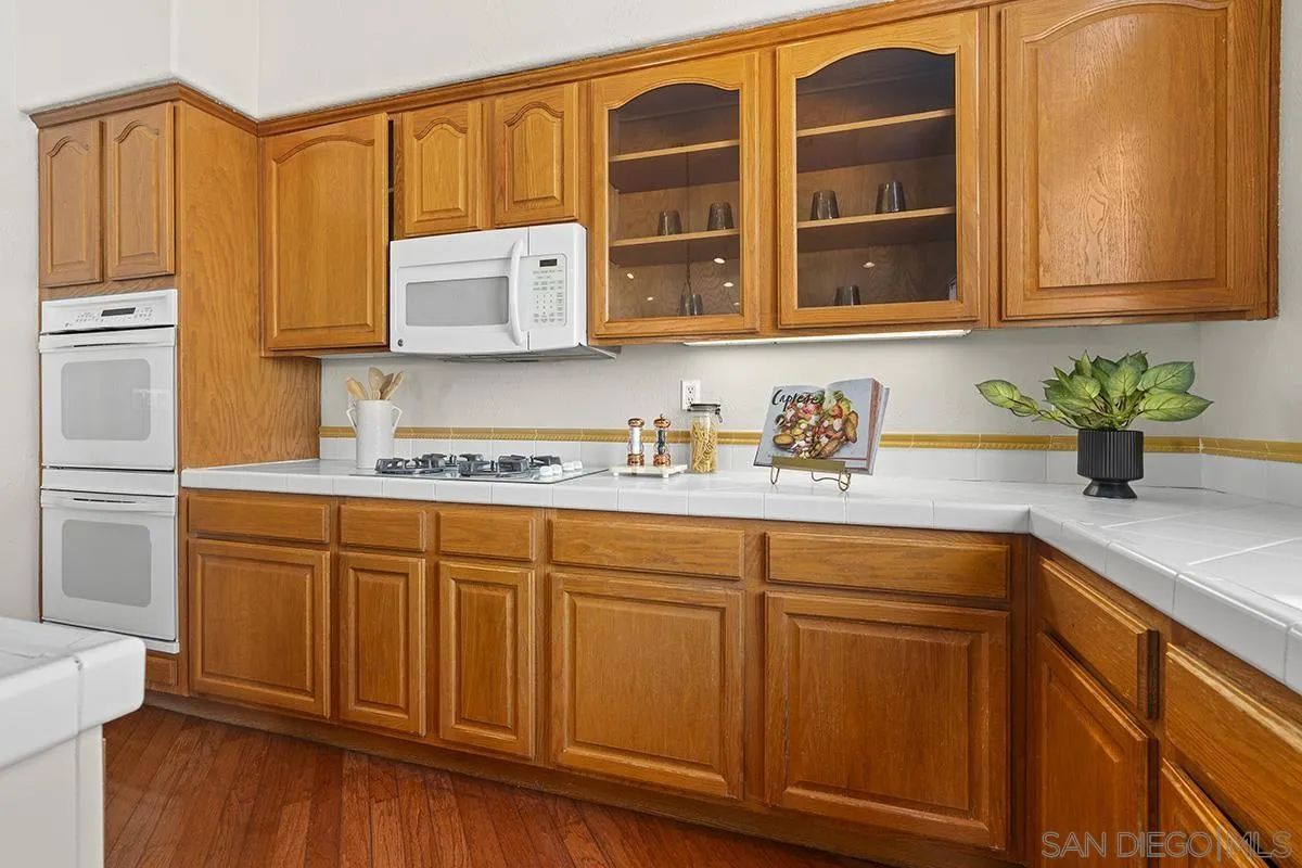 987 Palencia Court Chula Vista, CA 91910 - Photo 25 of 70 a kitchen with stainless steel appliances granite countertop a sink and cabinets