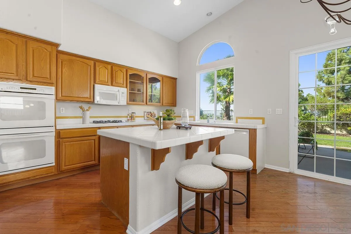 987 Palencia Court Chula Vista, CA 91910 - Photo 29 of 70 a kitchen with a sink cabinets and wooden floor