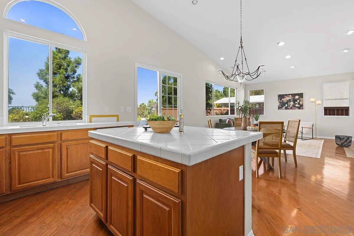 987 Palencia Court Chula Vista, CA 91910 - Photo 30 of 70 a kitchen with stainless steel appliances granite countertop a kitchen island hardwood floor and a sink