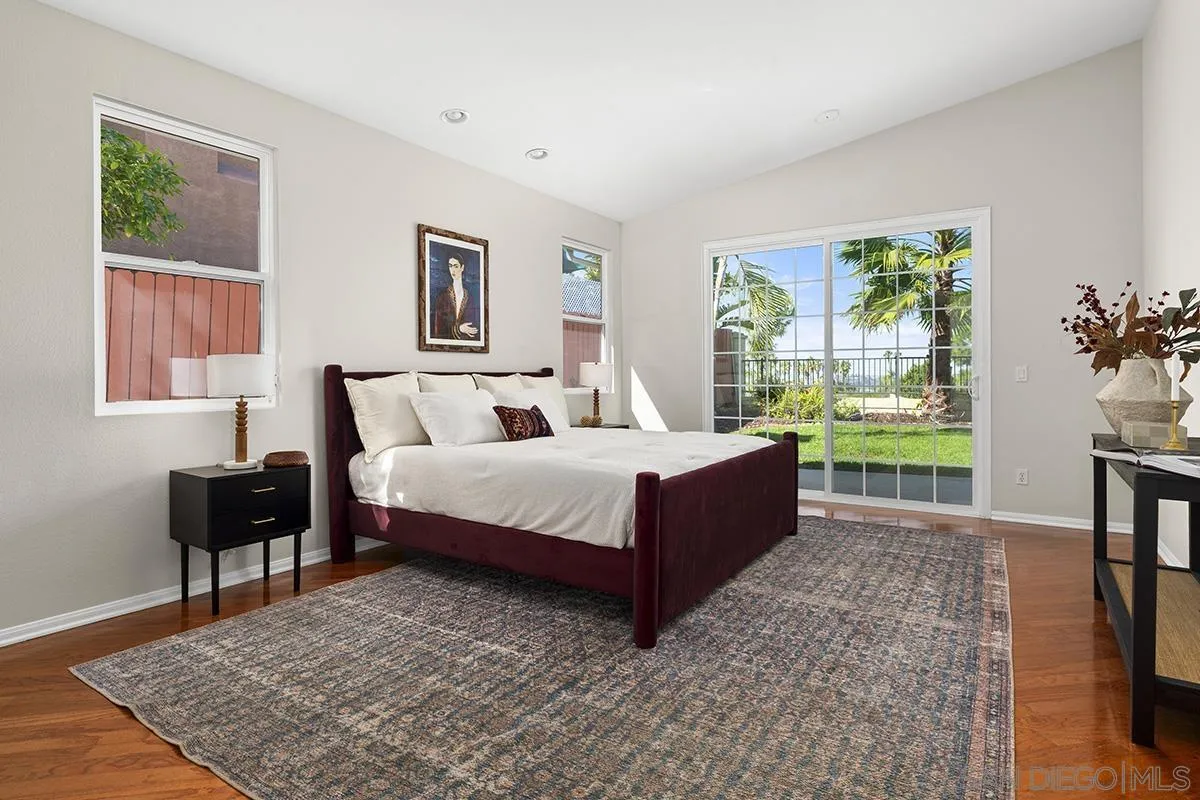 987 Palencia Court Chula Vista, CA 91910 - Photo 36 of 70 a bedroom with a bed lamps and window