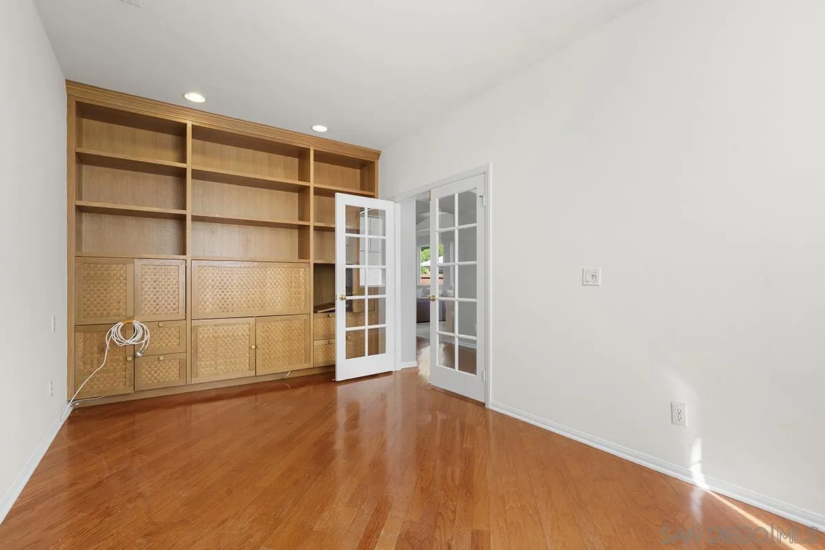 987 Palencia Court Chula Vista, CA 91910 - Photo 44 of 70 a view of an empty room with wooden floor and a window
