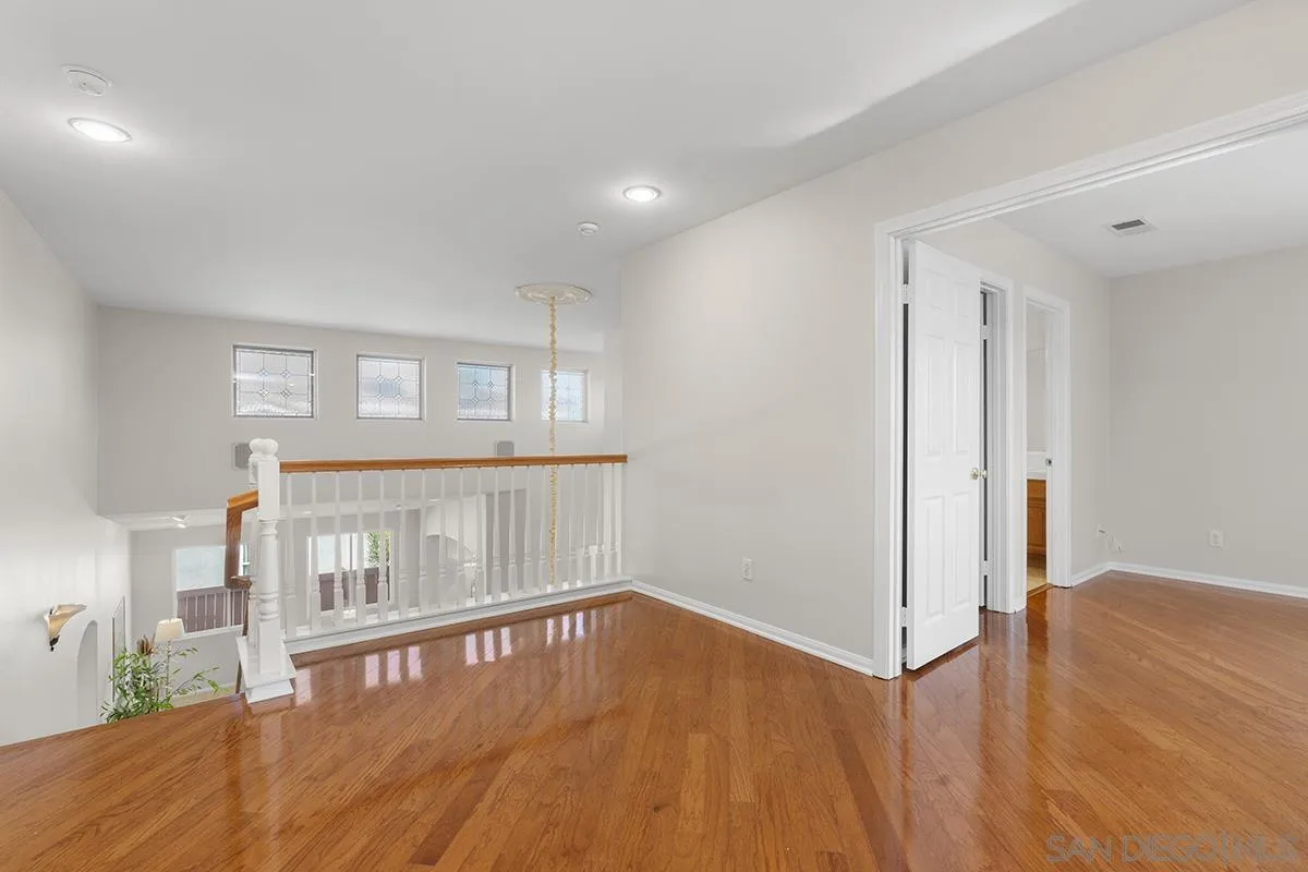 987 Palencia Court Chula Vista, CA 91910 - Photo 52 of 70 a view of an empty room with wooden floor and a window