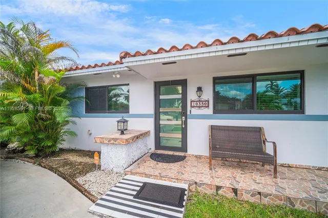 a view of a house with a yard and sitting area