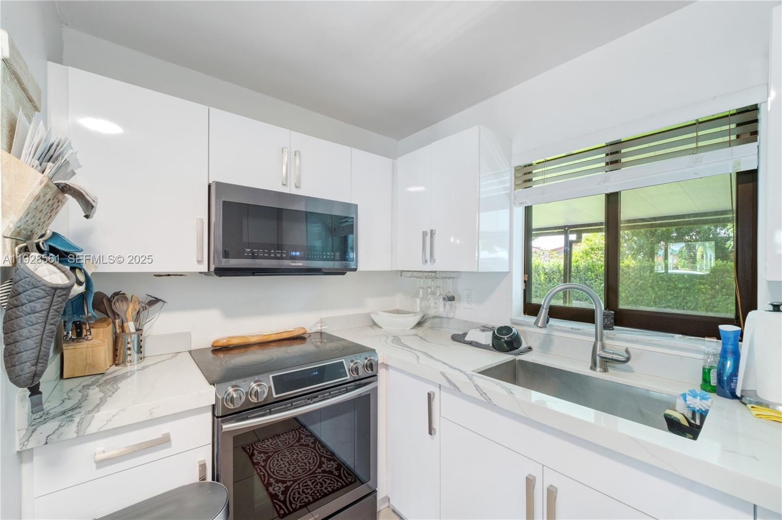 10350 Southwest 4th Street Sweetwater, FL 33174 - Photo 13 of 27 a kitchen with a sink appliances and cabinets