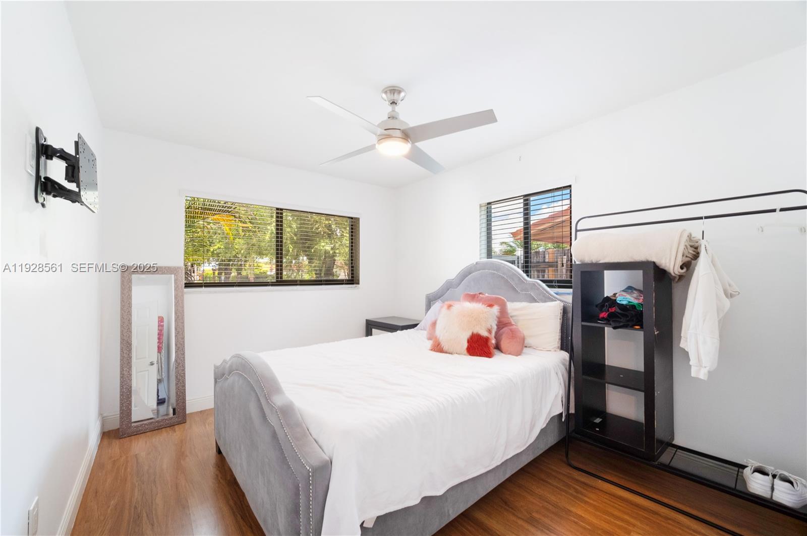 10350 Southwest 4th Street Sweetwater, FL 33174 - Photo 16 of 27 a bedroom with a large bed and a chandelier