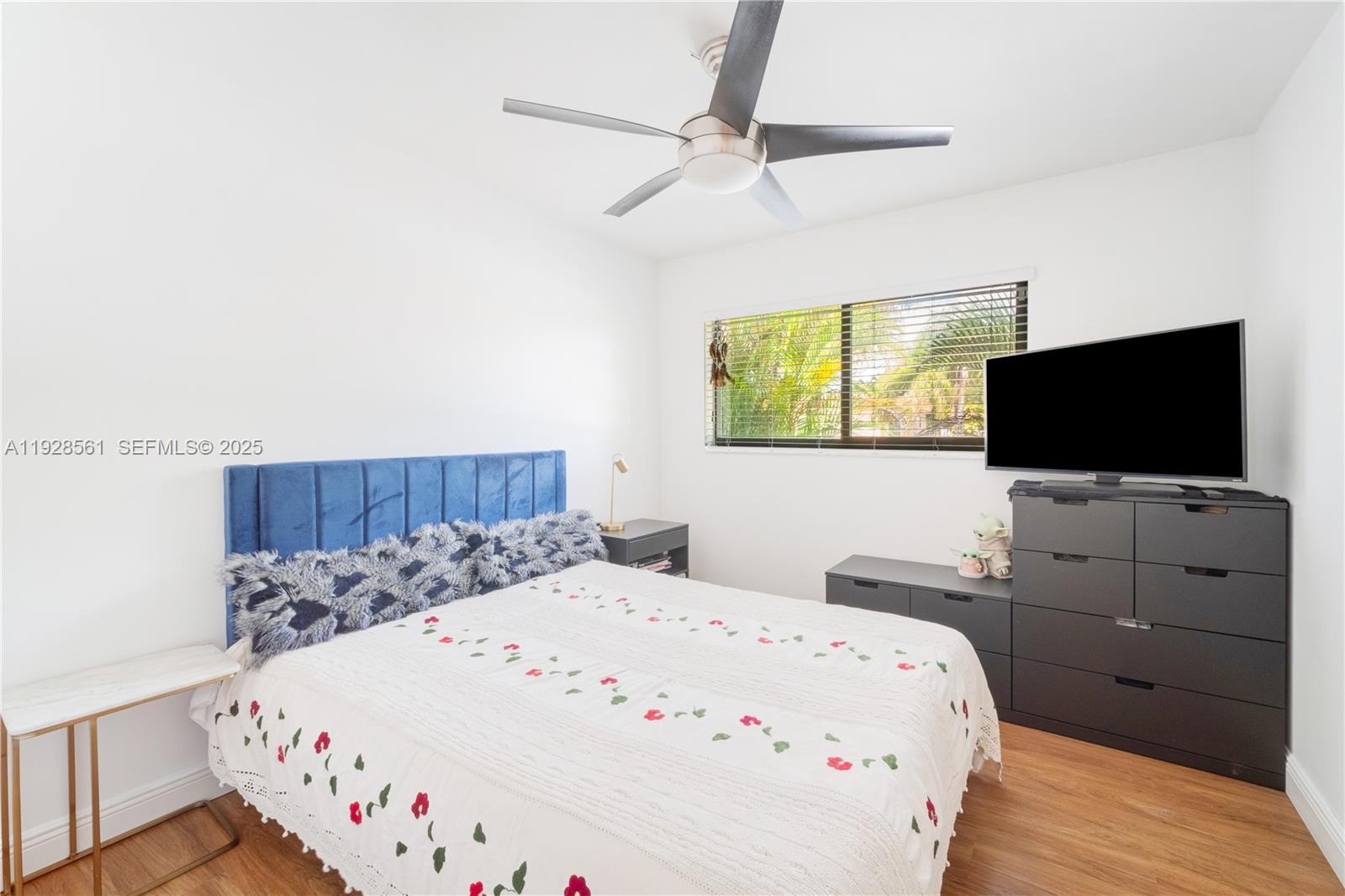 10350 Southwest 4th Street Sweetwater, FL 33174 - Photo 19 of 27 a large white bed in a bedroom next to a flat tv screen and a dresser