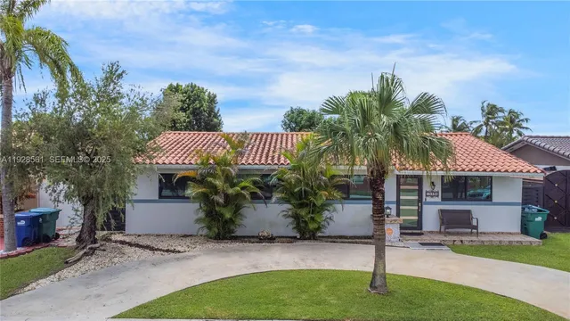 a view of a house with a yard and sitting area
