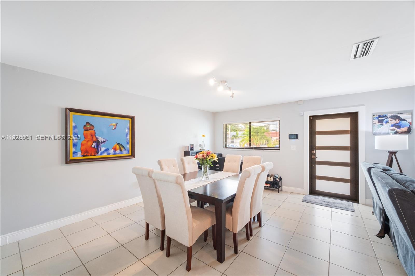 10350 Southwest 4th Street Sweetwater, FL 33174 - Photo 9 of 27 a view of a dining room with furniture and chandelier