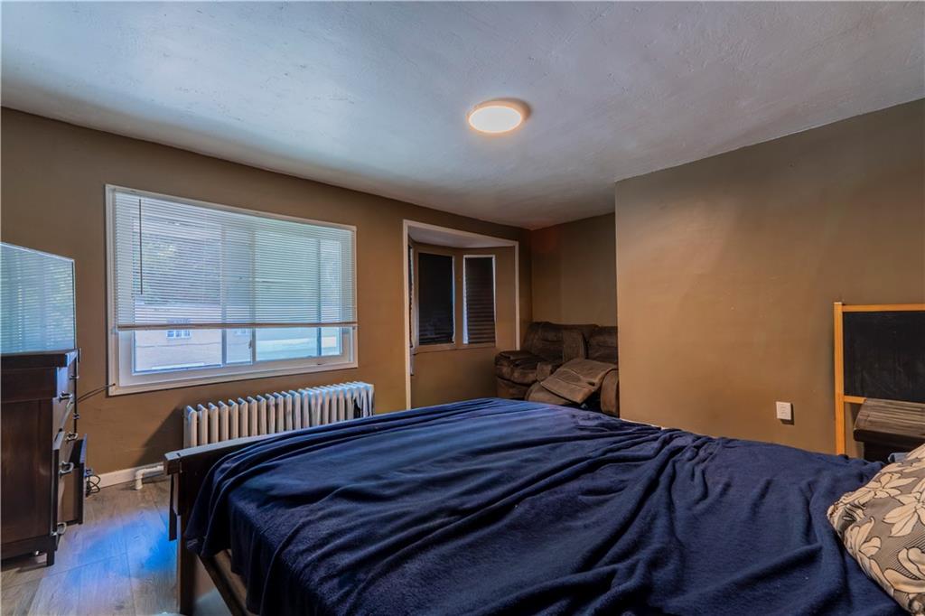 1012 Franklin Avenue Aliquippa, PA 15001 - Photo 12 of 21 a bedroom with a bed and wooden floor
