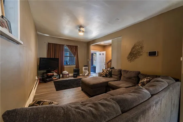 a living room with furniture fireplace and a flat screen tv