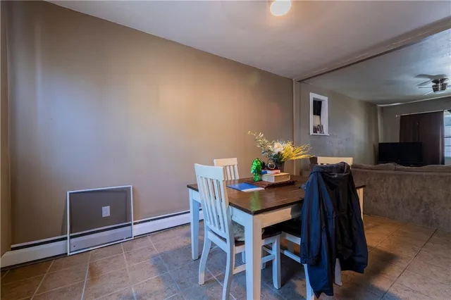 a dining room with furniture and wooden floor
